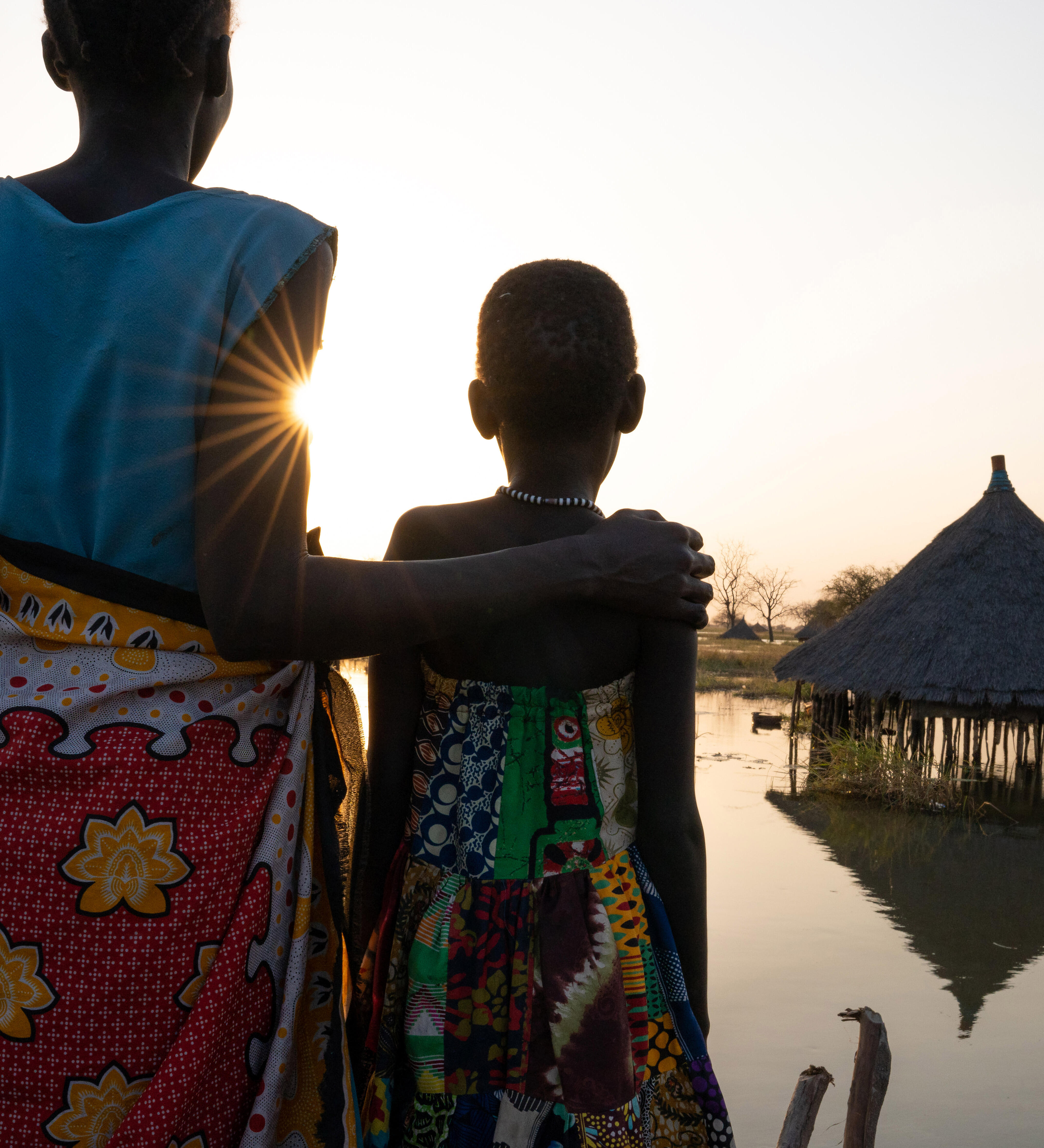 A mother and daughter look out over submerged houses in Panyagor in Twic East, Jonglei State in South Sudan. 