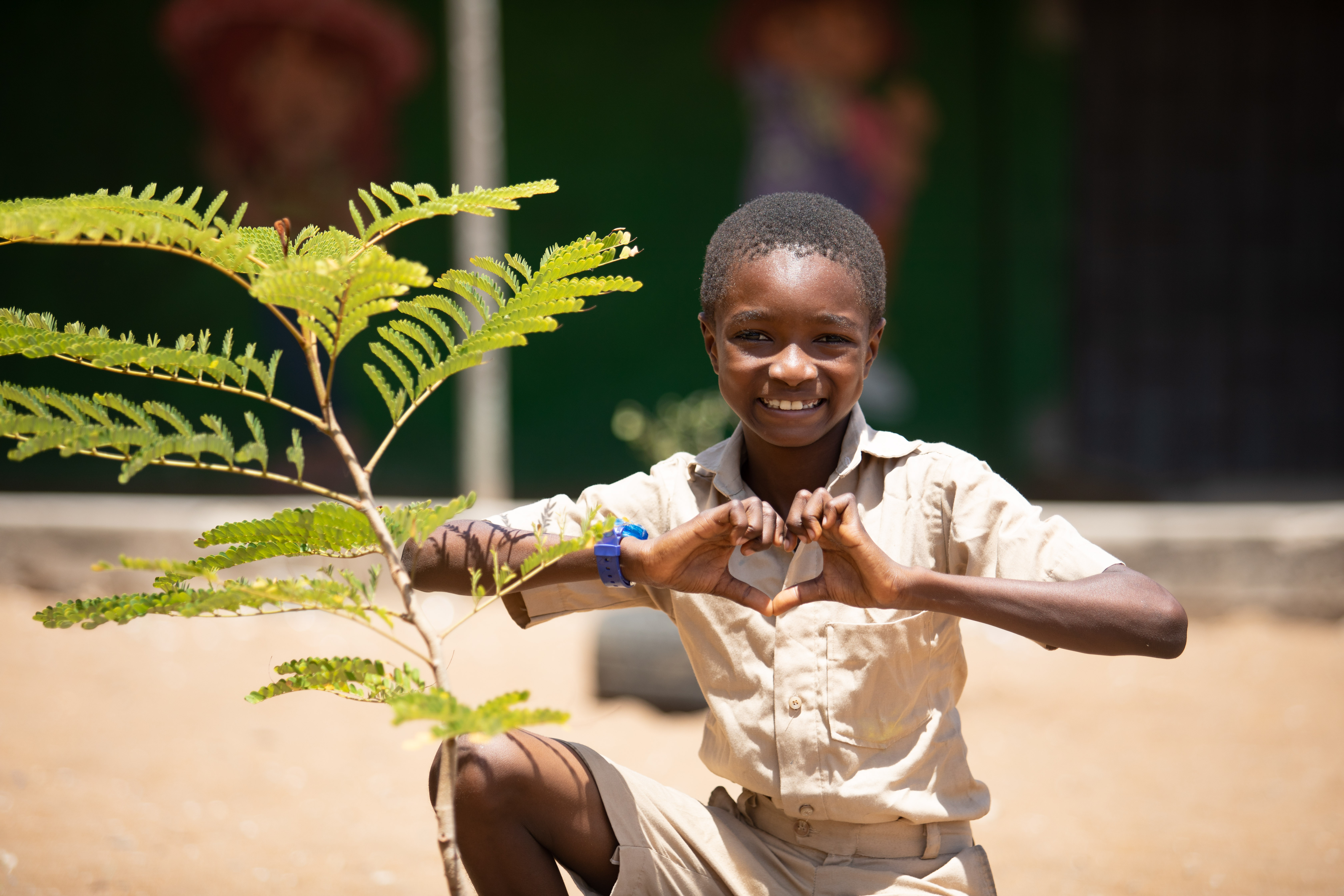 On 20 May 2020, a boy makes a heart symbol with his hands during Green School activities in Gonzagueville, a suburban of Abidjan, in the South of Côte d’Ivoire.  Children received environmental advice. They planted and watered trees and seeds, learned how to wash their hands properly.  Green schools have been implemented by UNICEF and young champions to ensure that every child can learn in a clean and healthy environment.  For every child, the right to a clean environment.