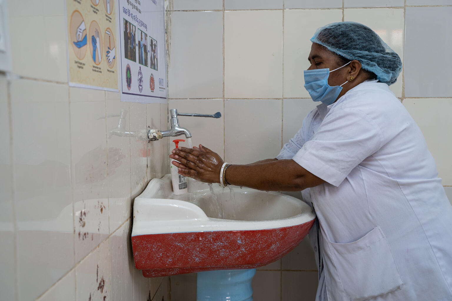 SDH Chitrakot, Odisha: Nursing officer SAtyabharna Mahanta washing her hands at the handwash station. This facility is Kayakalp certified.