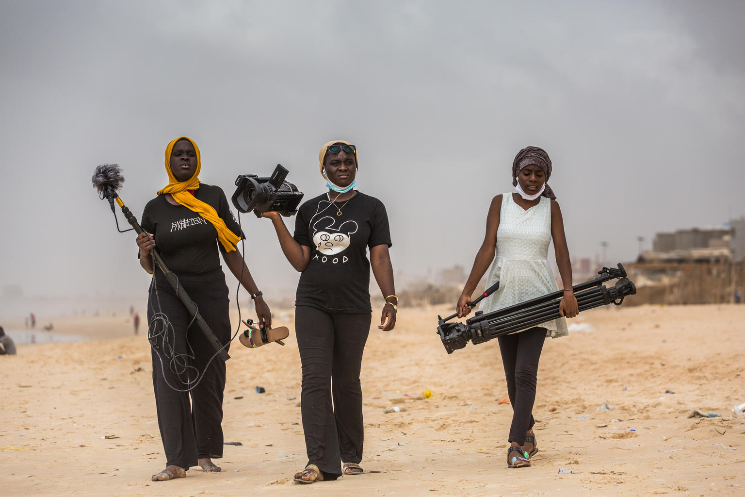 On 3 August 2020 in Dakar, Senegal, Oumou Kalsoum Diop (centre), 18, walks with Fatim Thiandoum (left) and Astou Diallo, both 17, looking to conduct spontaneous interviews with people on the beach to be used as part of a documentary on democracy in the country.