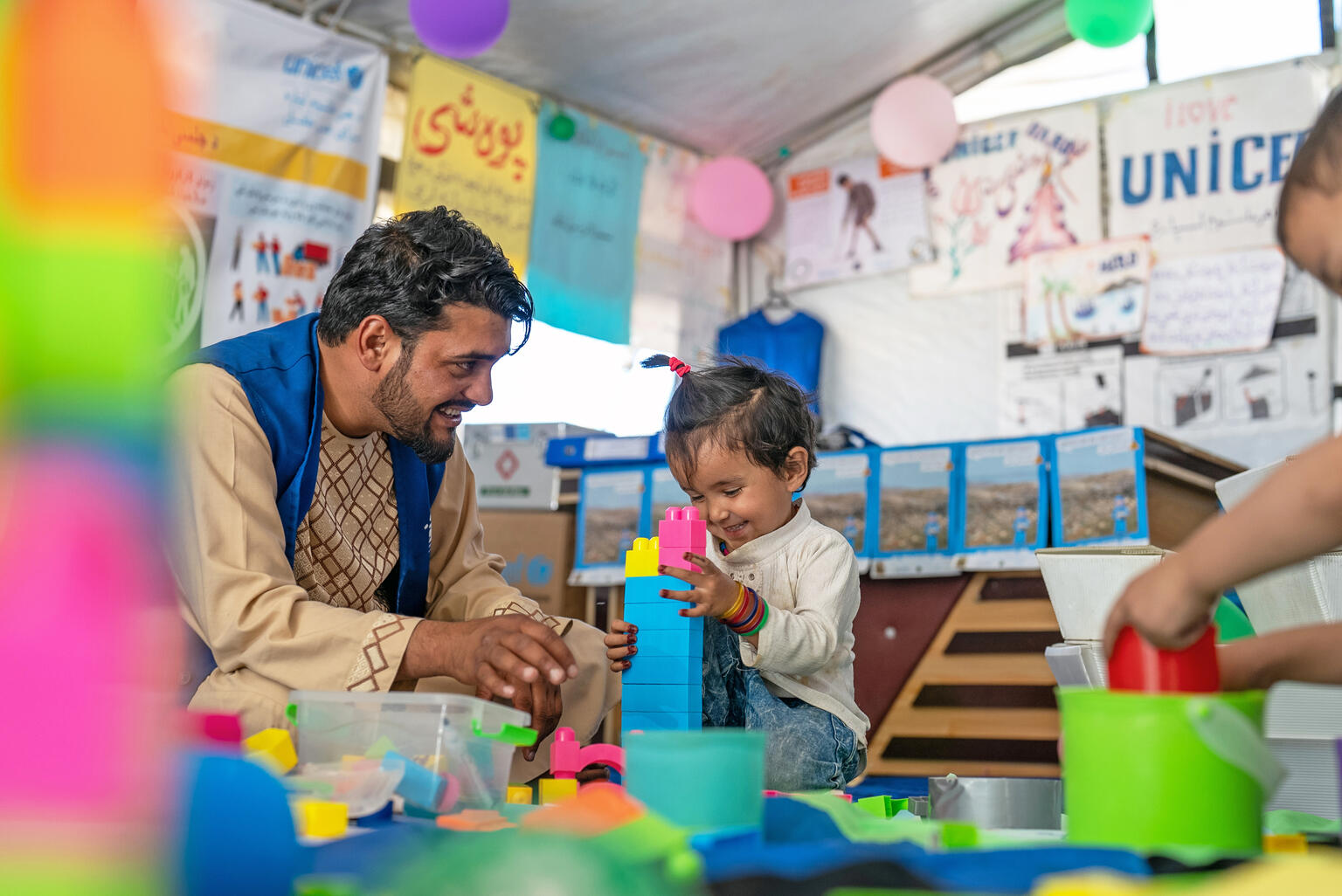 On 7 May 2024, 3-year-old Kubra plays at the UNICEF-supported child-friendly space on the Torkham border crossing with Pakistan in Nangarhar Province, eastern Afghanistan.