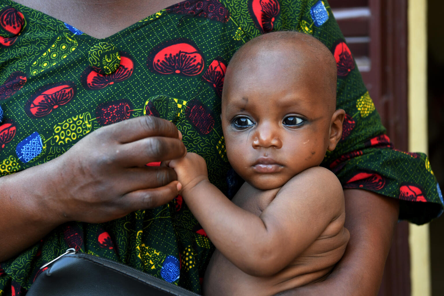 A mother cuddling her baby, in Bobo-Dioulasso, in the Southwest of Burkina Faso.