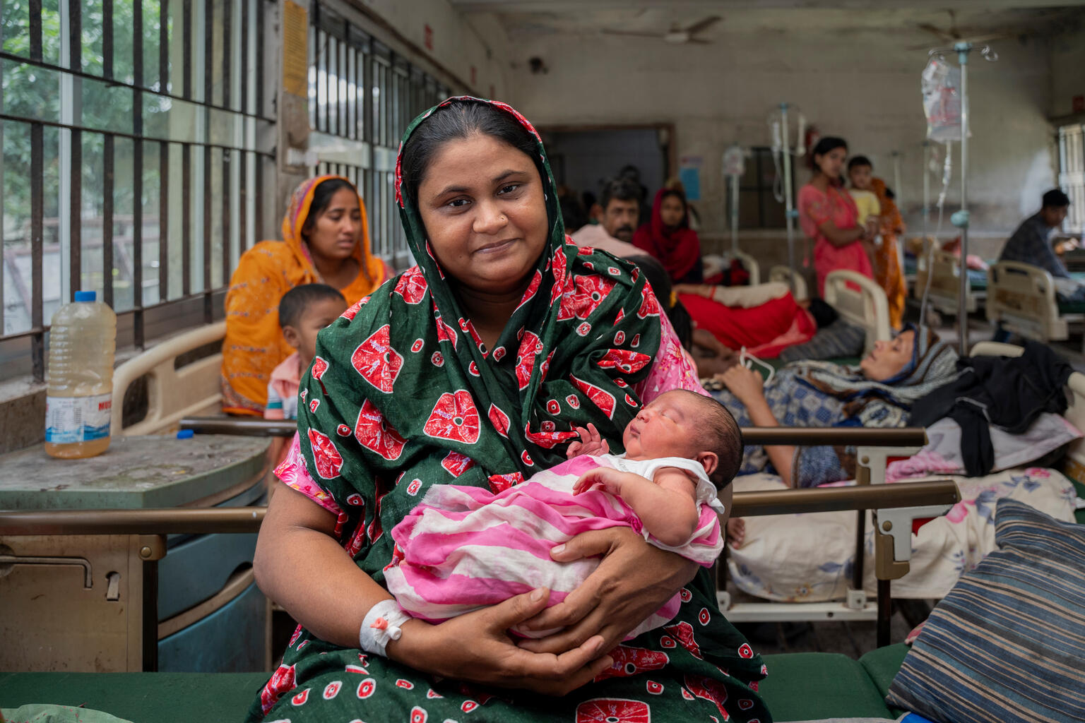 Ayesha Akhtar (30) came to the Upazila Health Complex in Fulgazi, Feni, for her third delivery. She lived in South Baraia with her family. When floodwaters entered her house, she and her family moved to a neighbor’s house. There, she went into labor, was admitted to the hospital, and gave birth to a baby the next day. Her daughter is now playing with her newborn brother.