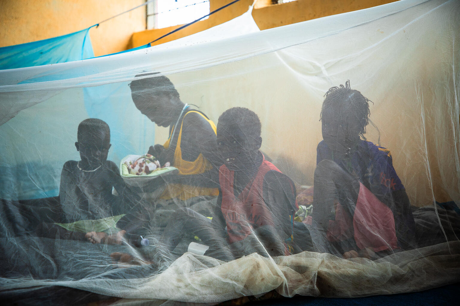 Lingo and her 4 children took refuge in the village school after heavy rains flooded her home. "What worries me most are the mosquitoes. We protect ourselves as best we can with mosquito nets, but I'm afraid my children will get sick, including my very young baby," says Lingo.