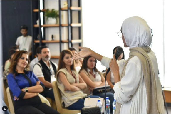 Ola speaking to a group about plastic pollution