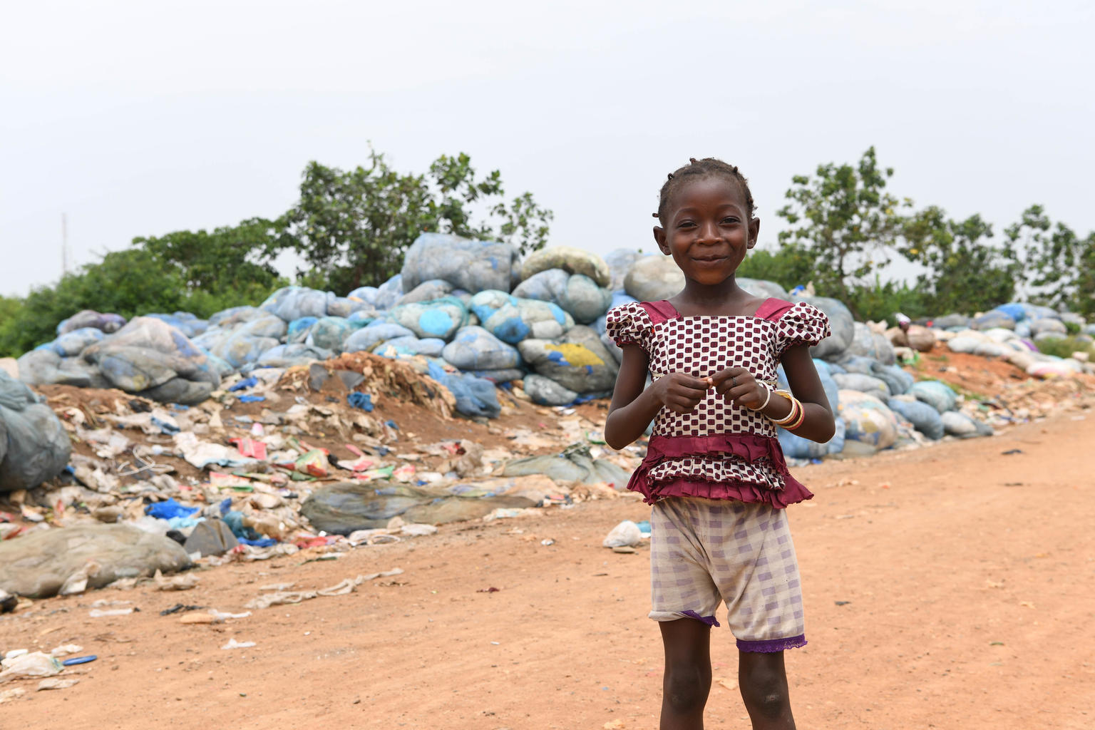 Girl playing in a landfill in Abidjan, Côte d'Ivoire.