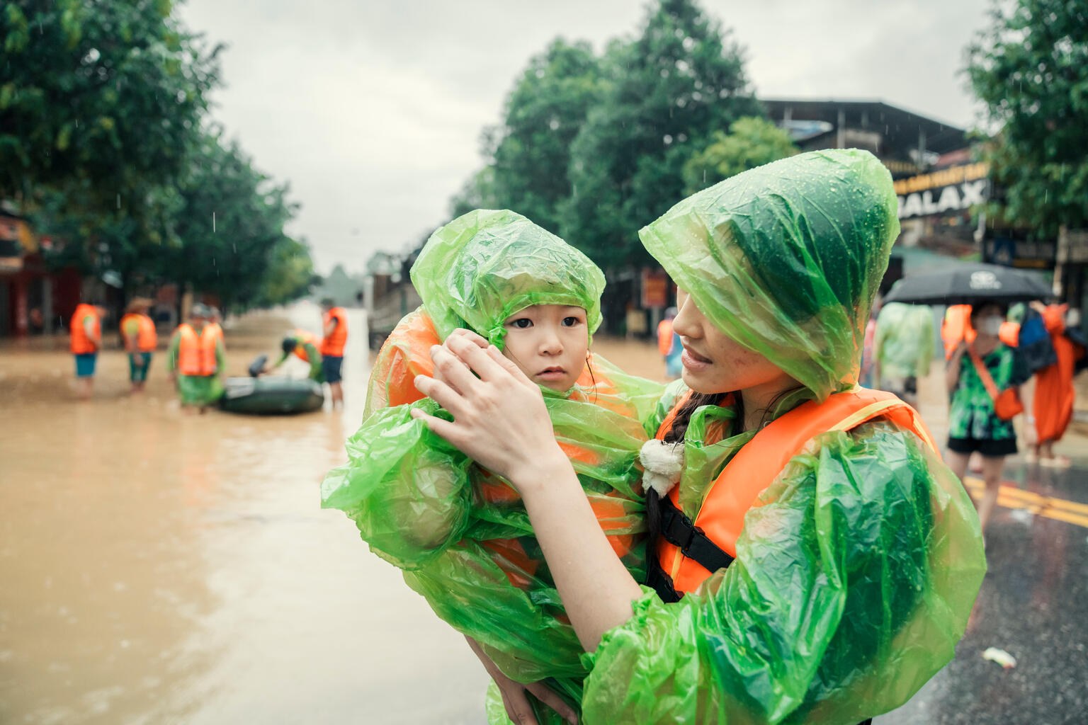 Anh Nguyet, born in 2006, carries her younger sister, Vu Ha Anh, as they evacuate from the severe flood caused by Super Typhoon Yagi in Thai Nguyen City.