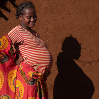 Pregnant mother holds her belly