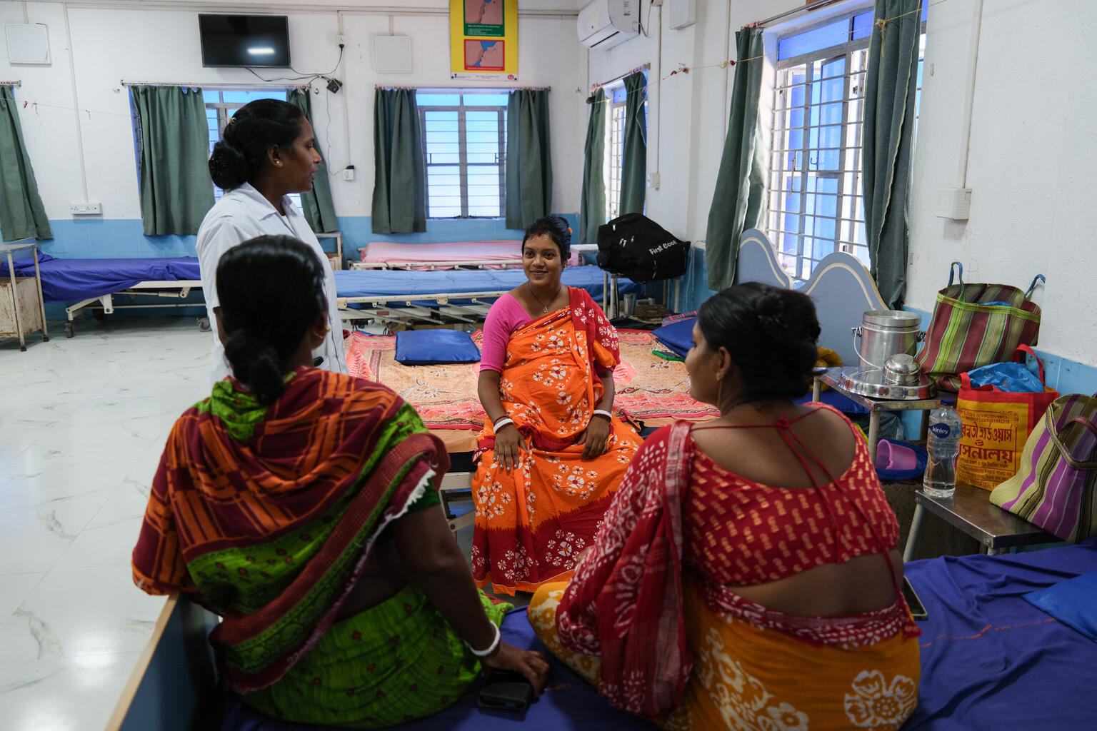 Sabita Mondal, 23 a pregnant woman arrives at the Gosaba Rural Hospital Mother’s Waiting Hut (MWH), with her mother in law, Kabita Mandal, with the on-duty nurse, Mayna Mandal, who orients and welcomes her into the MWH.